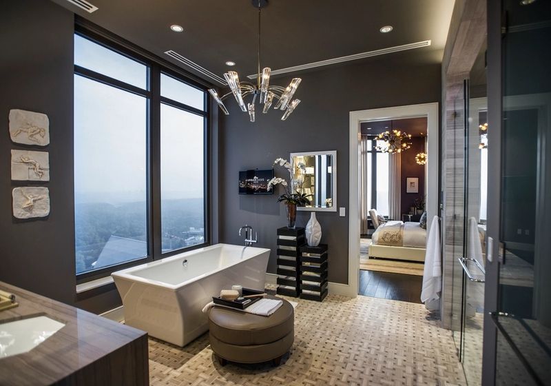 Modern bathroom with freestanding tub and large windows